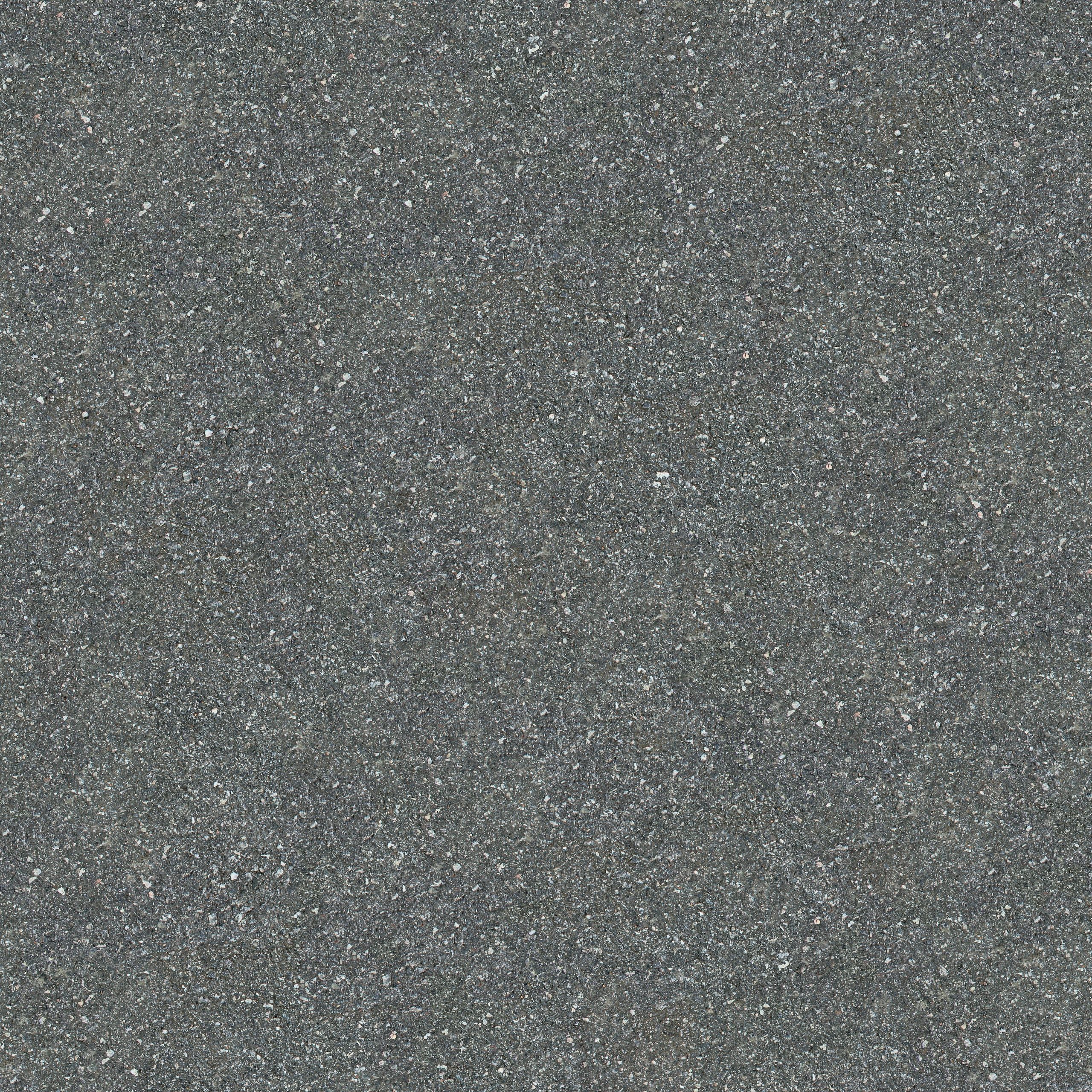 Gros plan détaillé sur l'asphalte gris rugueux mettant en évidence sa texture et sa surface rugueuse.